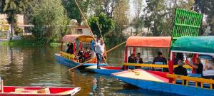 a group of people on boats in the water at TrajinerasNativitasAdventureTours in Mexico City
