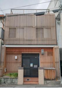 a building with a wooden facade with a door at -鳴間の宿 Narumanoyado- Kyoto Aquarium-MUS in Kyoto