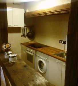 a kitchen with a washing machine and a sink at Appart'Tourisme Blois Châteaux de la Loire in Blois