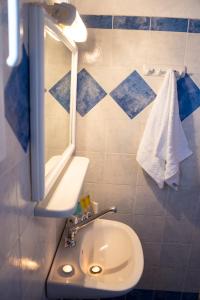 a bathroom with a sink and a mirror at Act Art Skiathos in Skiathos