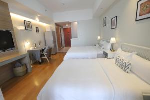 Ліжко або ліжка в номері Shanghai Suju Service Apartment Pudong Wanda Plaza Zhoupu Subway Station Branch