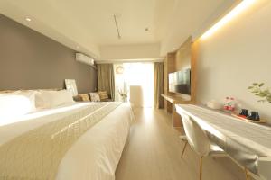 Ліжко або ліжка в номері Shanghai Suju Service Apartment Pudong Wanda Plaza Zhoupu Subway Station Branch