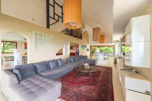 a living room with a couch and a table at 芭东日月双海景别墅 in Patong Beach