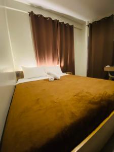 Postel nebo postele na pokoji v ubytování ZenSuites Hotel Tacloban + 37 fotografií