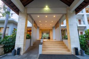 a hallway of a building with stairs and plants at Bintang Flores Hotel in Labuan Bajo