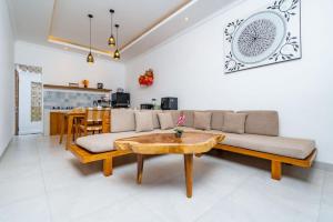 a living room with a couch and a table at Villa Made Ubud in Ubud