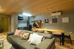 a living room with a couch and a table at 丹羽邸 in Ōdōri