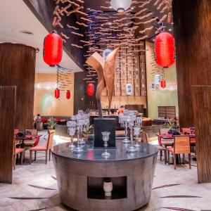 a restaurant with a table with wine glasses on it at Centara Grand Mirage Beach Resort Pattaya in North Pattaya +287 photos