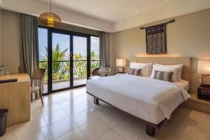 a bedroom with a large bed and a balcony at Bintang Flores Hotel in Labuan Bajo +41 photos