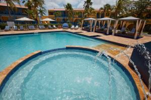 a swimming pool with a fountain in a hotel at Divi Flamingo Beach Resort in Kralendijk