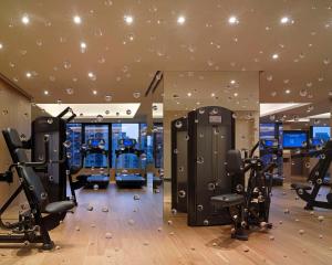 a gym with treadmills and elliptical machines at Grand Hyatt Taipei in Taipei