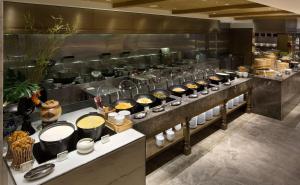 a kitchen with a bunch of food on display at Grand Hyatt Taipei in Taipei