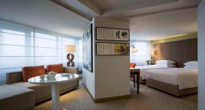 a hotel room with two beds and a couch and a table at Grand Hyatt Taipei in Taipei +37 photos