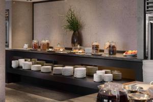 a display case with plates and jars of food at Grand Hyatt Taipei in Taipei