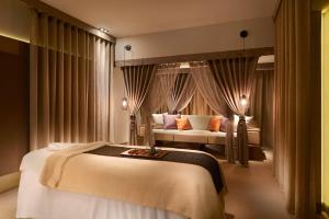 a hotel room with a bed and a couch at Grand Hyatt Taipei in Taipei