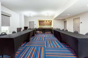 a conference room with chairs and a stage in the background at Hampton Inn Orlando-International Airport in Orlando +27 photos