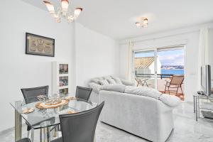 a white living room with a table and chairs at Casa Maritima in La Herradura