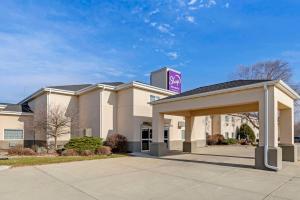a building with a sign on top of it at Sleep Inn & Suites Charles City in Charles City