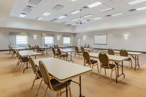 a classroom with tables and chairs and a whiteboard at Sleep Inn & Suites Charles City in Charles City +32 photos