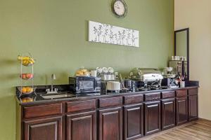 a kitchen with a counter top with a microwave at Sleep Inn & Suites Charles City in Charles City