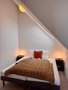 a bedroom with a bed with two night stands at Panoramic Holiday Apartment - Dagmar in Ebeltoft