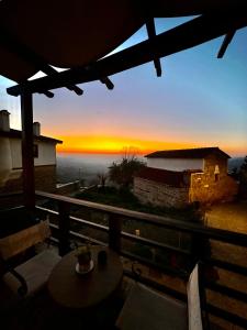 a view of a sunset from the balcony of a house at Varosi Guesthouse in Edessa