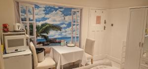 a dining room with a view of the beach through a window at The White House in Waltham Cross
