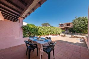 a table and chairs sitting on a patio at Apartment in San Teodoro 23143 in San Teodoro