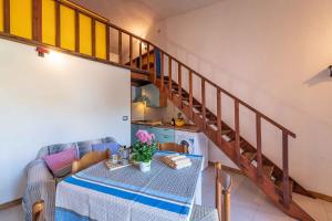 a dining room with a table and a staircase at Apartment in San Teodoro 23143 in San Teodoro +13 photos