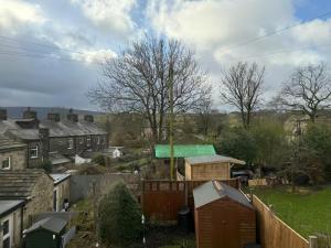 a view of a village with houses and a fence at 2Bed Cottage - Trawden - Pet Friendly - Sleeps4 in Colne +15 photos