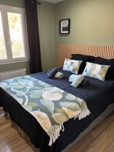 a bedroom with a bed with a blue comforter at Villa La Liberté in Arles-sur-Tech +54 photos