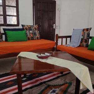 a living room with two beds and a coffee table at Bella Casa Malindi Casuarina in Malindi