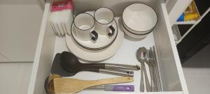 a drawer filled with dishes and utensils at Jia嘉 Homestay - Kuching Riverine Diamond Resort in Kuching
