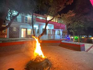 a fire in front of a building at night at Shourya Homes in Arvi