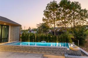 a swimming pool in the backyard of a house at Six elements pool villa khaokho in Khao Kho