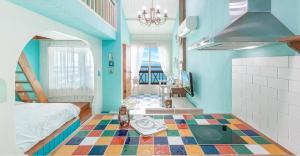 a bedroom with a bed and a colorful floor at Ganghwa hana & alice spa pension in Incheon +2 photos