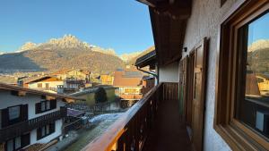 a balcony with a view of a city and mountains at Appartamento Villa Nicole in Transacqua