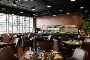 a restaurant with tables and chairs and a bar at Cristal Hotel Abu Dhabi in Abu Dhabi