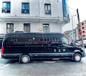 a black van parked in front of a building at Dem Premium Hotel - Round Trip Airport Service - Istanbul International Airport in Arnavutköy