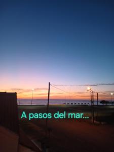 a pasos del mar sunset with the words a pasos del mar at AltaMar in Playa Unión