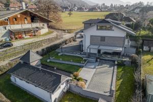 an aerial view of a house with a yard at Les Coteaux du Chateau - OG IMMO in Menthon-Saint-Bernard