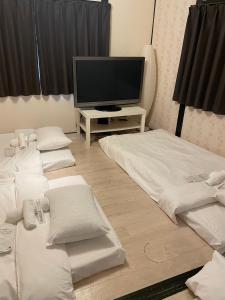 Postel nebo postele na pokoji v ubytování Hakko Ichiu
