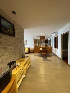 a kitchen and living room with a table and chairs at Baan Poo Lom Condo in Hua Hin