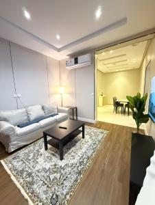 a living room with a couch and a table at RIVIERA دخول ذاتي self check-in in Riyadh