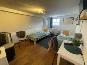 a room with a bed and a couch and a table at Gartenlaube Marburg in Marburg an der Lahn