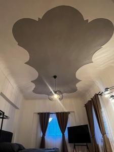 a living room with a ceiling with a butterfly painted on it at Old Town Secret in Graz