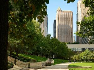 a park in the middle of a city with tall buildings at Fairmont Chicago Millennium Park in Chicago