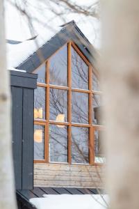 a window in a house with snow on the ground at Sora chalet - Modern house near Rusutsu Resort in Rusutsu