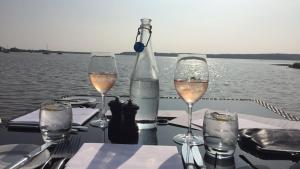 a table with glasses of wine and a bottle at Harford en-suite Rooms in Lymington
