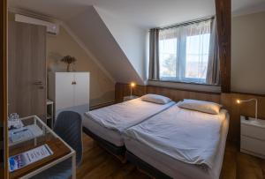 Postel nebo postele na pokoji v ubytování Dobosi Vendégház